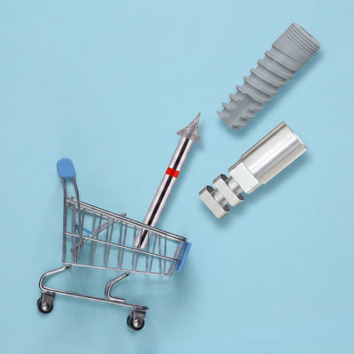 Dental product photo showing a small shopping cart on a light blue background, with dental implant components, a dental bur, and a threaded implant displayed beside it.